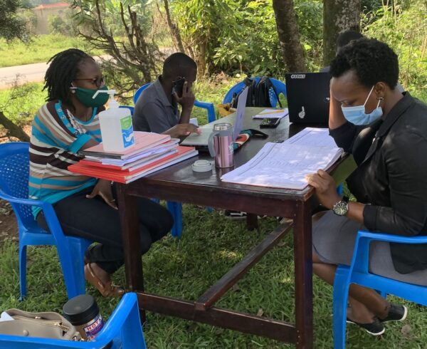 METS staff interacting with Mildmay's Elizabeth during the DREAMS Data Audit at Kalule in Nyimbwa Subcounty